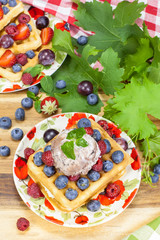 Belgian waffles with fresh berry fruits ,grapes and ice cream