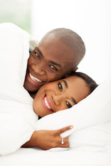 african couple sleeping in bed