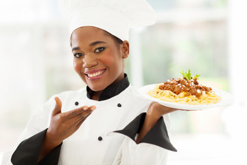afro american chef presenting spaghetti