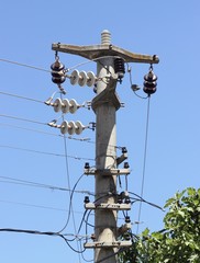 Telegraph poles against a blue sky