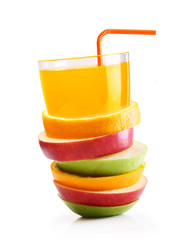 Stack of orange fruit and apples slices with juice.