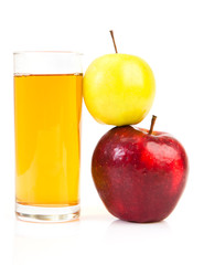 Delicious apple juice in glass and apples isolated on white