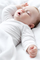 Carefree sleeping little baby on a bed