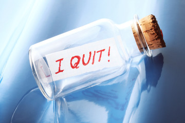 A concept of a bottle with a message "I quit"