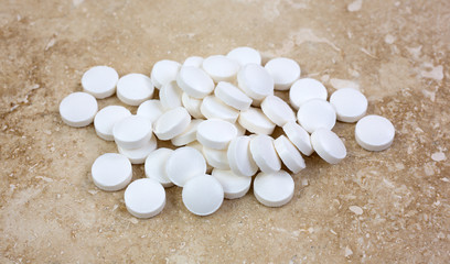 Melatonin tablets on marble tile