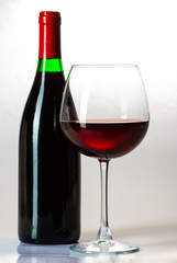 Wine bottle and a glass filled with wine isolated on white