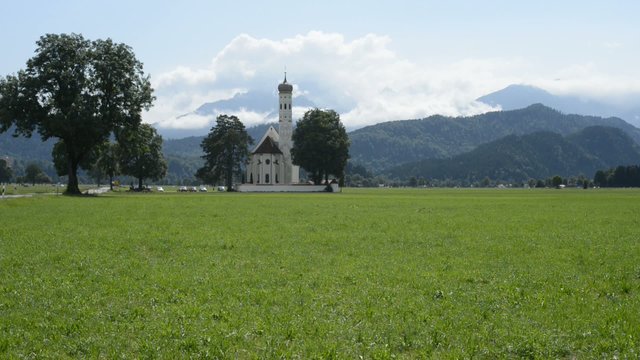 Bavaria, Germany beautiful view to the Saint Coloman Church in the background the panorama of the alps