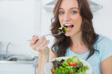 Brunette eating healthy salad