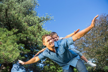 Son playing with his dad outside