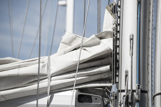 Close up image of sail and mast pulley system on yacht sailboat