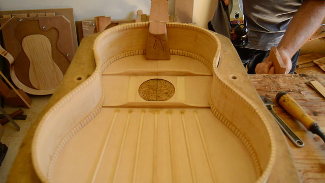 Luthier Making a guitar piece, tilt