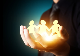 Paper family in hand, insurance concept