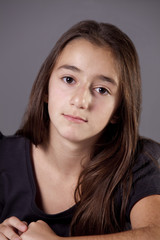 Young teenage girl, looking at camera thoughtfully.