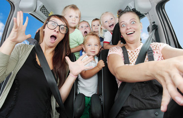 Crazy mothers with her children riding to holidays.