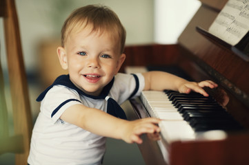 little funny boy plays piano