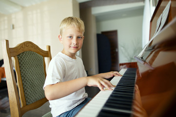 little funny boy plays piano