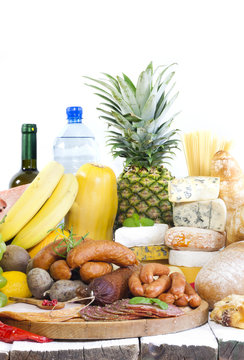 Variety of grocery products fruits meat cheese and bread