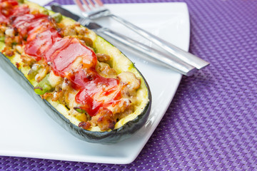 Zucchini halves stuffed with minced meat, vegetables and cheese