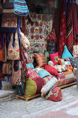 Fototapeta na wymiar Fabrics, textiles,bags and turkish rugs at a bazaar in Turkey