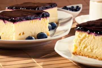Cheesecake with blueberries and a cap of coffee