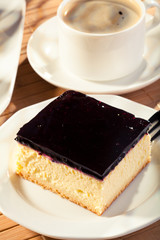 Cheesecake with blueberries and a cap of coffee