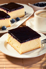 Cheesecake with blueberries and a cap of coffee