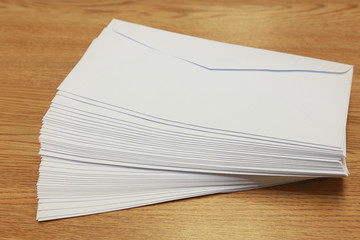 stack of white envelopes on a table