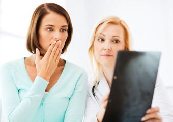 doctor with patients looking at x-ray