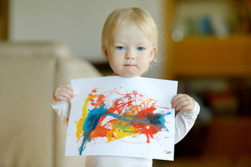 Little toddler girl displaying her picture