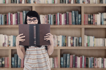 Asian female student read book at library