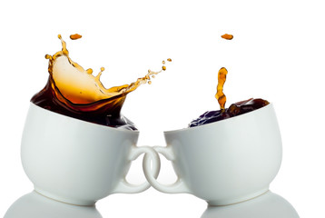 two cups of coffee creating splashes. Love symbol