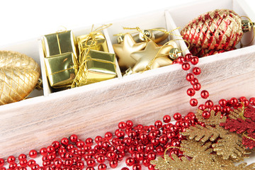Wooden box filled with christmas decorations, isolated on white