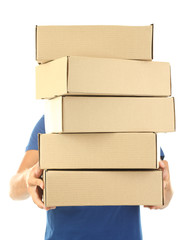 Young delivery man holding parcels, isolated on white