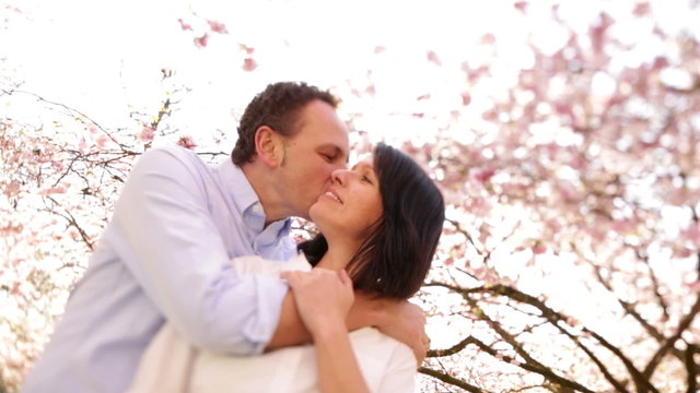 Happy mature couple in spring, kissing and hugging
