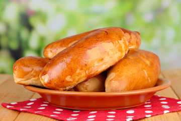 Fresh baked pasties, on wooden table, on bright background