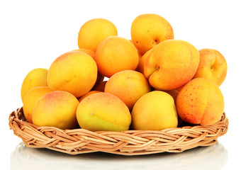 Fresh natural apricot in wicker basket isolated on white