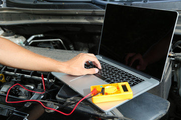 Professional car mechanic working in auto repair service