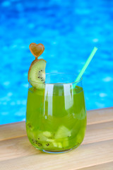 Tasty cocktail on swimming pool background