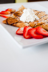 crepe with fresh strawberries sprinkled with sugar