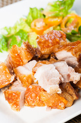 fried pork belly and oriental salad on a side