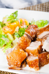 fried pork belly and oriental salad on a side
