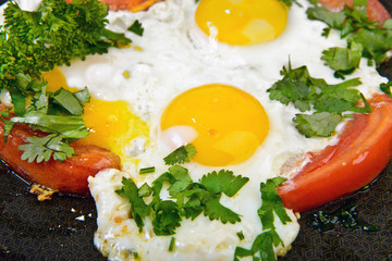 Roasted eggs and tomato at pan