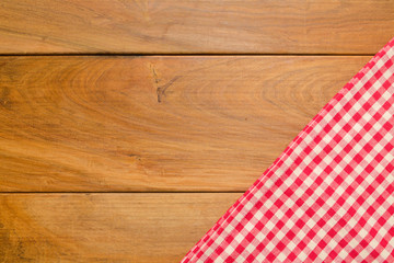 Background with wooden tabletop and checked tablecloth