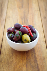 Marinated olives on wooden table