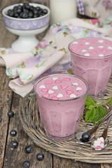 Yogurt with blueberry on wooden background