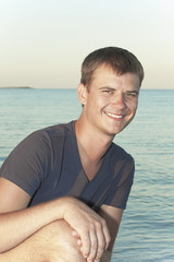 Fototapeta premium young guy on the background of the sea