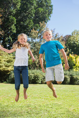 Brother and sister jumping together