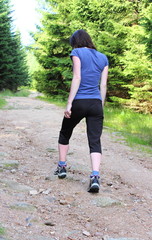 Photo of woman hiking up a mountain trail