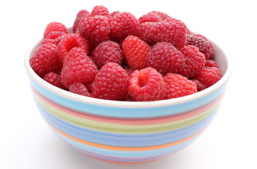 Fresh raspberries with a bowl on a white background