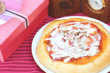 Pizza and gift boxes on red background